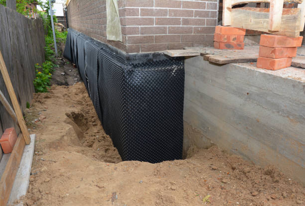 Happy homeowners after waterproofing job in Munith